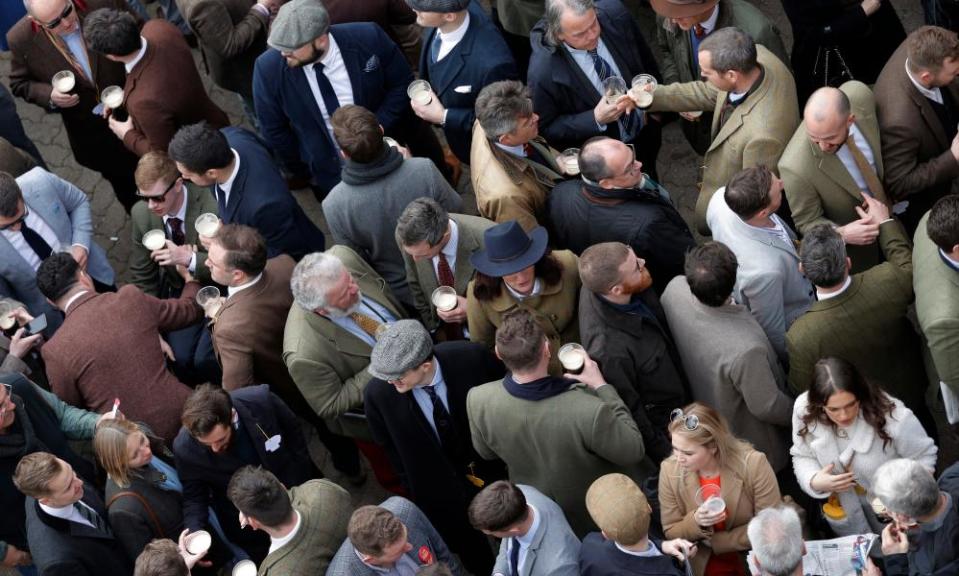 Racegoers socialising at Cheltenham on the last day of the festival.