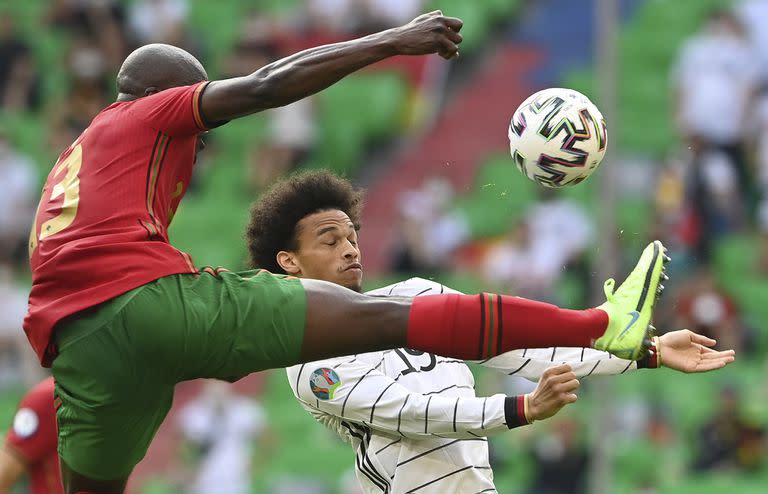 Portugal's Danilo Pereira challenges Germany's Leroy Sane during the Euro 2020 soccer championship group F match between Portugal and Germany at the football arena stadium in Munich, Saturday, June 19, 2021. (Christof Stache/Pool via AP)