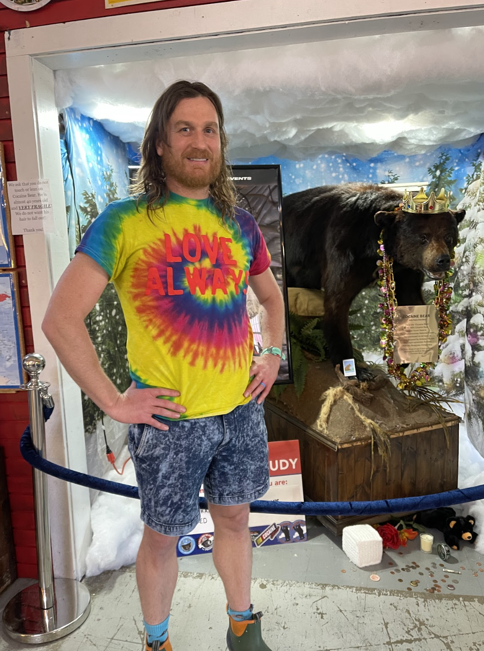 Griffin VanMeter, co-owner of the Lexington-based Kentucky for Kentucky Fun Mall, poses proudly in front of the real Cocaine Bear, which has been on display at his store since 2015. (Credit: David Artavia for Yahoo Entertainment) 