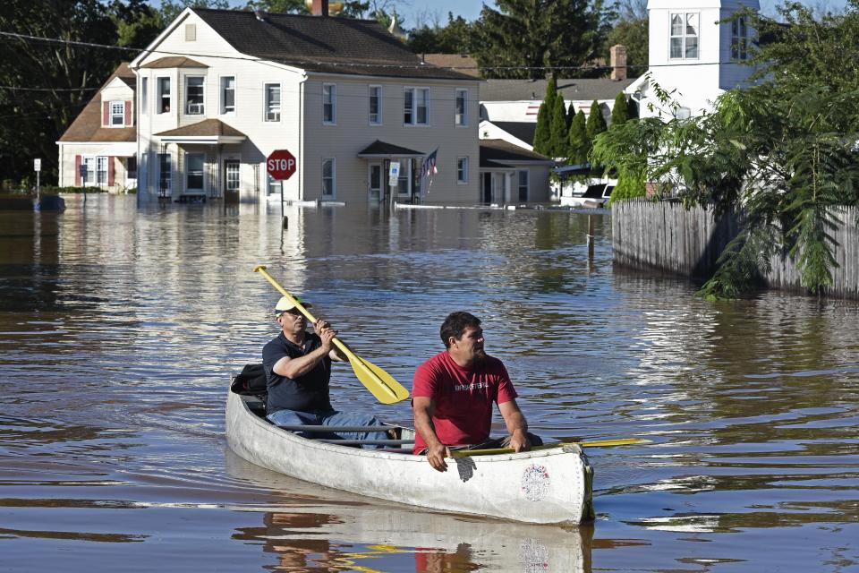 Residents canoe through floodwater in the aftermath of Hurricane Ida in Manville, NJ, Thursday, Sept. 2, 2021. A stunned U.S. East Coast has woken up to a rising death toll, surging rivers and destruction after the remnants of Hurricane Ida walloped the region with record-breaking rain. (AP Photo/Carlos Gonzalez)