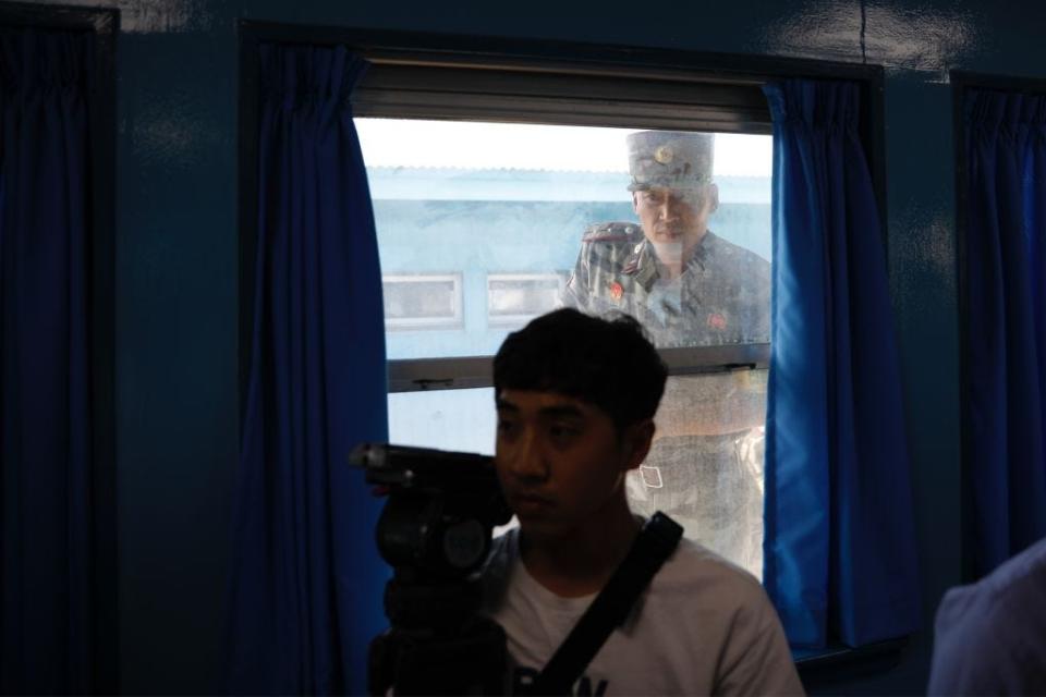 A North Korean soldier watches a member of the media in the DMZ