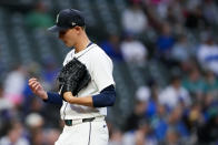 Seattle Mariners starting pitcher George Kirby looks down at his hand after facing the Kansas City Royals during the fourth inning of a baseball game Monday, May 13, 2024, in Seattle. (AP Photo/Lindsey Wasson)