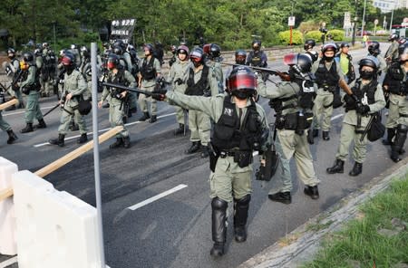 Riot police officers patrol the street during an anti-government protest in Tai Po district, in Hong Kong