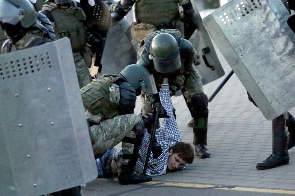 Law enforcement officers detain a man during an opposition rally to protest against the presidential inauguration in Minsk on Sept. 23.