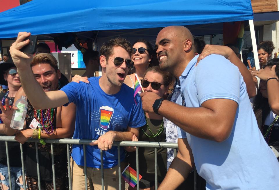 Former NFL player and Democratic congressional candidate Colin Allred, right, poses with supporters as he marches in the Dallas Pride Parade on Sept.  16, 2018 in Dallas.