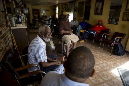 Lenny Clay (2nd from front) talks with other men at his barber shop in Baltimore, Maryland April 29, 2015. REUTERS/Eric Thayer