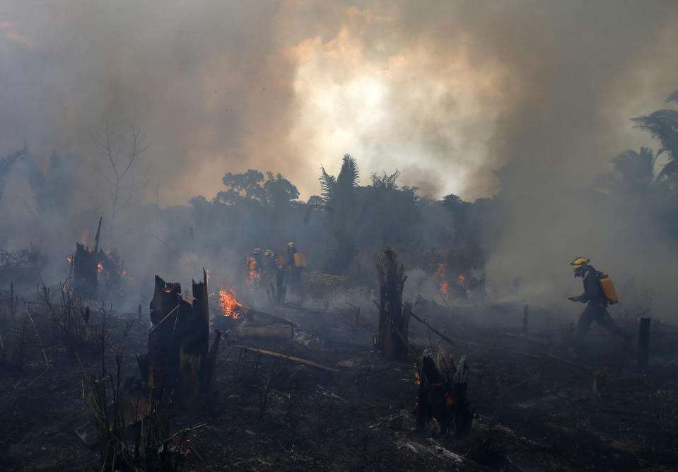 FILE - Fire brigade members work to put out fires in Apui, Amazonas state, Brazil, Sept. 21, 2022. Deforestation in the Brazilian Amazon slowed slightly last year, a year after a 15-year high, according to closely watched numbers published Wednesday, Nov. 30. (AP Photo/Edmar Barros, File)