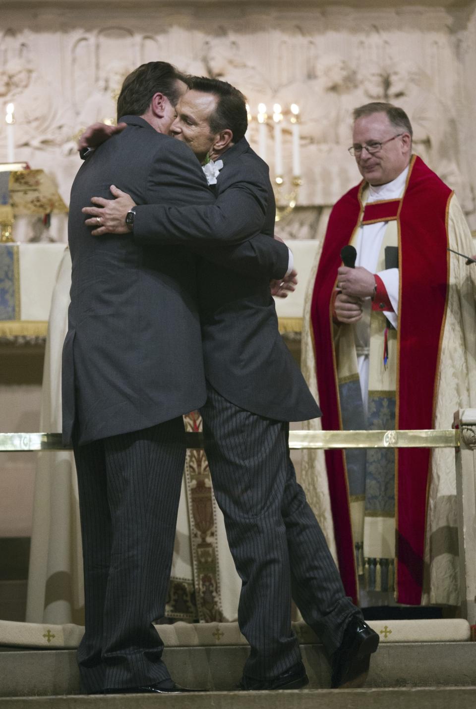 FILE - Tim Bostic, right, and Tony London hug each other after the Witnessing of the Vow ceremony at Christ & St. Luke's Episcopal Church for their wedding ceremony on Saturday, May 2, 2015 in Norfolk, Va. When the United Methodist Church removed anti-LGBTQ language from its official rules in recent days, it marked the end of a half-century of debates over LGBTQ inclusion in mainline Protestant denominations. The moves sparked joy from progressive delegates, but the UMC faces many of the same challenges as Lutheran, Presbyterian and Episcopal denominations that took similar routes, from schisms to friction with international churches to the long-term aging and shrinking of their memberships. (The' N. Pham/The Virginian-Pilot via AP, file)