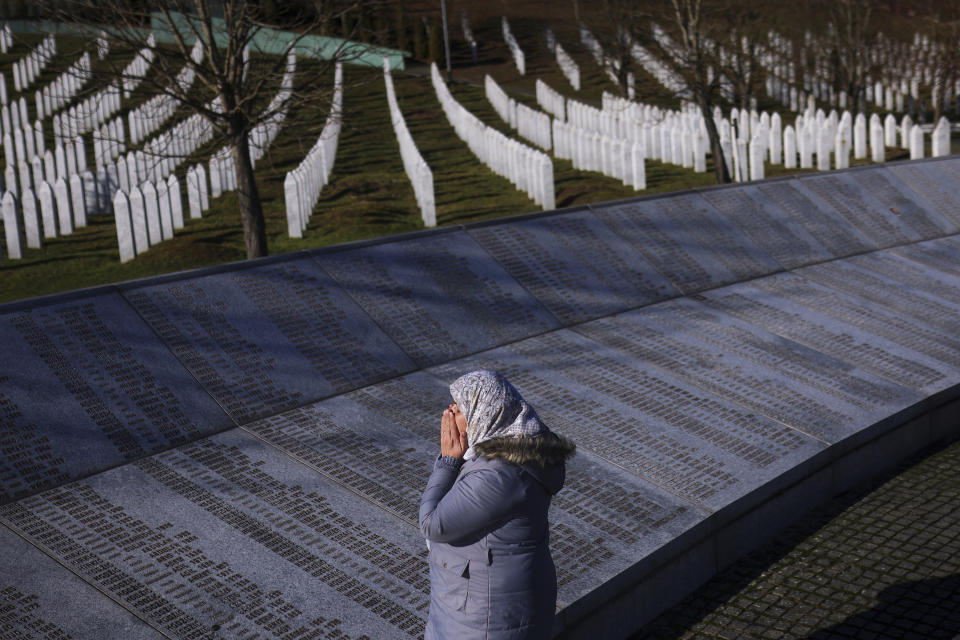 A Bosnian Muslim woman prays next to the monument with names of those killed in the Srebrenica genocide, at the Srebrenica Memorial Center, on International Holocaust Remembrance Day, in Potocari, Bosnia, Saturday, Jan. 27, 2024. Jews and Muslims from Bosnia and abroad gathered in Srebrenica Saturday to jointly observe International Holocaust Remembrance Day and promote compassion and dialogue amid rising global sectarian hatred fueled by Israel’s war in Gaza. (AP Photo/Armin Durgut)