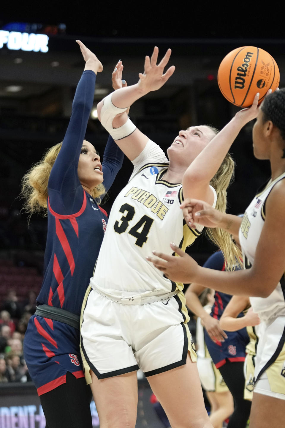 Purdue forward Caitlyn Harper (34) shoots on St. John's forward Rayven Peeples (20) in the second half of a First Four women's college basketball game in the NCAA Tournament Thursday, March 16, 2023, in Columbus, Ohio. (AP Photo/Paul Sancya)