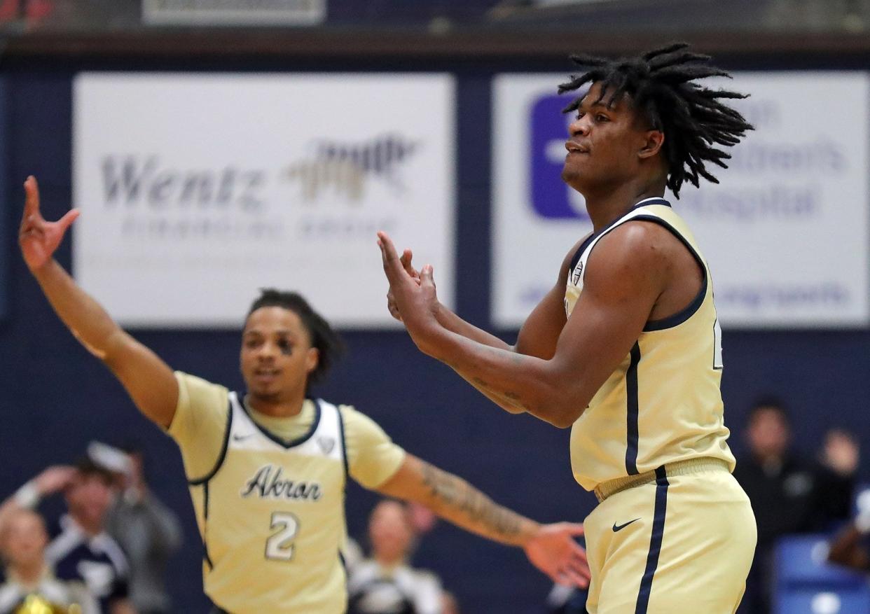 Akron Zips forward Mikal Dawson (22) celebrates after making a three during the first half of an NCAA basketball game Western Michigan Broncos, Tuesday, Jan. 18, 2022, in Akron, Ohio. [Jeff Lange/Beacon Journal]