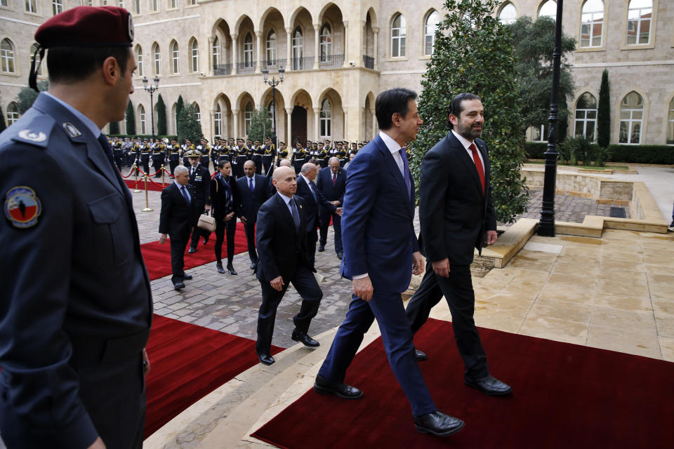 Lebanese Prime Minister Saad Hariri, right, receives his Italian counterpart Giuseppe Conte, second right, at the Government House in Beirut, Lebanon, Thursday, Feb. 7, 2019. (AP Photo/Bilal Hussein)