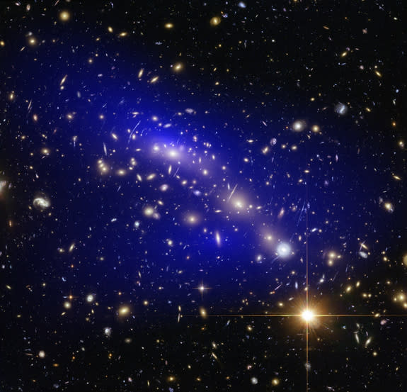 The galaxy cluster MACS J0416.1-2403 is seen with a dark matter map overlay (in blue) in this view captured by the Hubble Space Telescope Frontier Fields project.