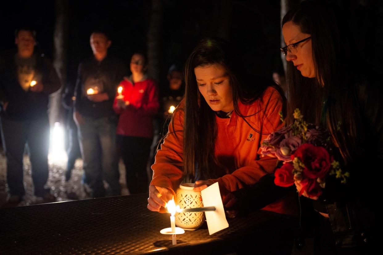 Courtney Sevin and Rachel Hernandez light candles during a Dec. 13, 2019, vigil for Heidi Broussard, an Austin woman who was strangled in what authorities say was a plot to kidnap her newborn.