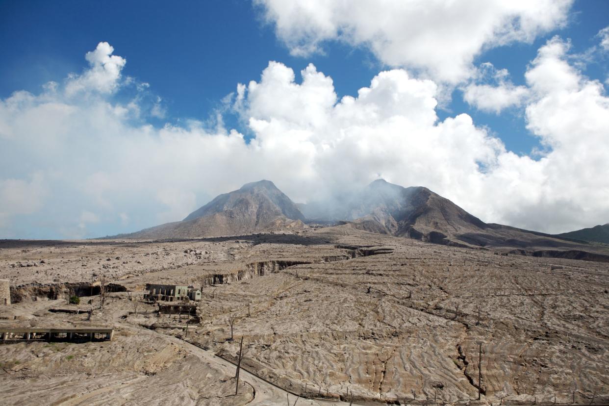 abandoned gray town with volcano in background