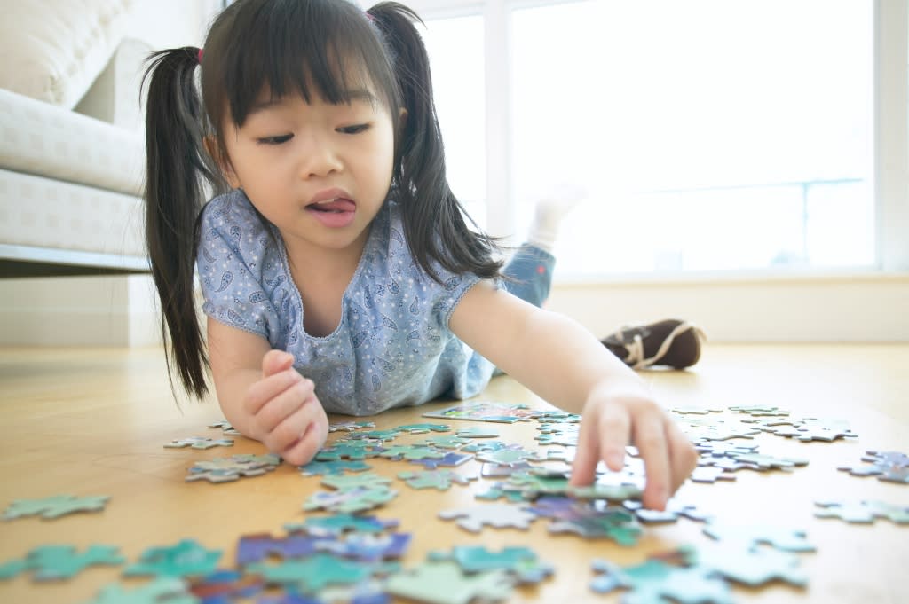 Child Playing with Puzzle