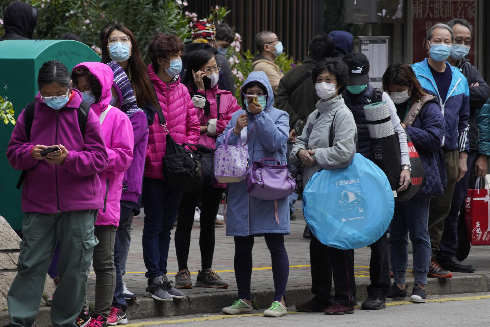 In this Feb. 5, 2020, photo, citizens line up to buy face masks in Hong Kong. The city's often-tumultuous street protests had already slowed in the past two months. Now they have ground to an almost complete halt as attention focuses on how to avoid a recurrence of the SARS pandemic, which killed about 300 people in Hong Kong in 2002-03. (AP Photo/Vincent Yu)