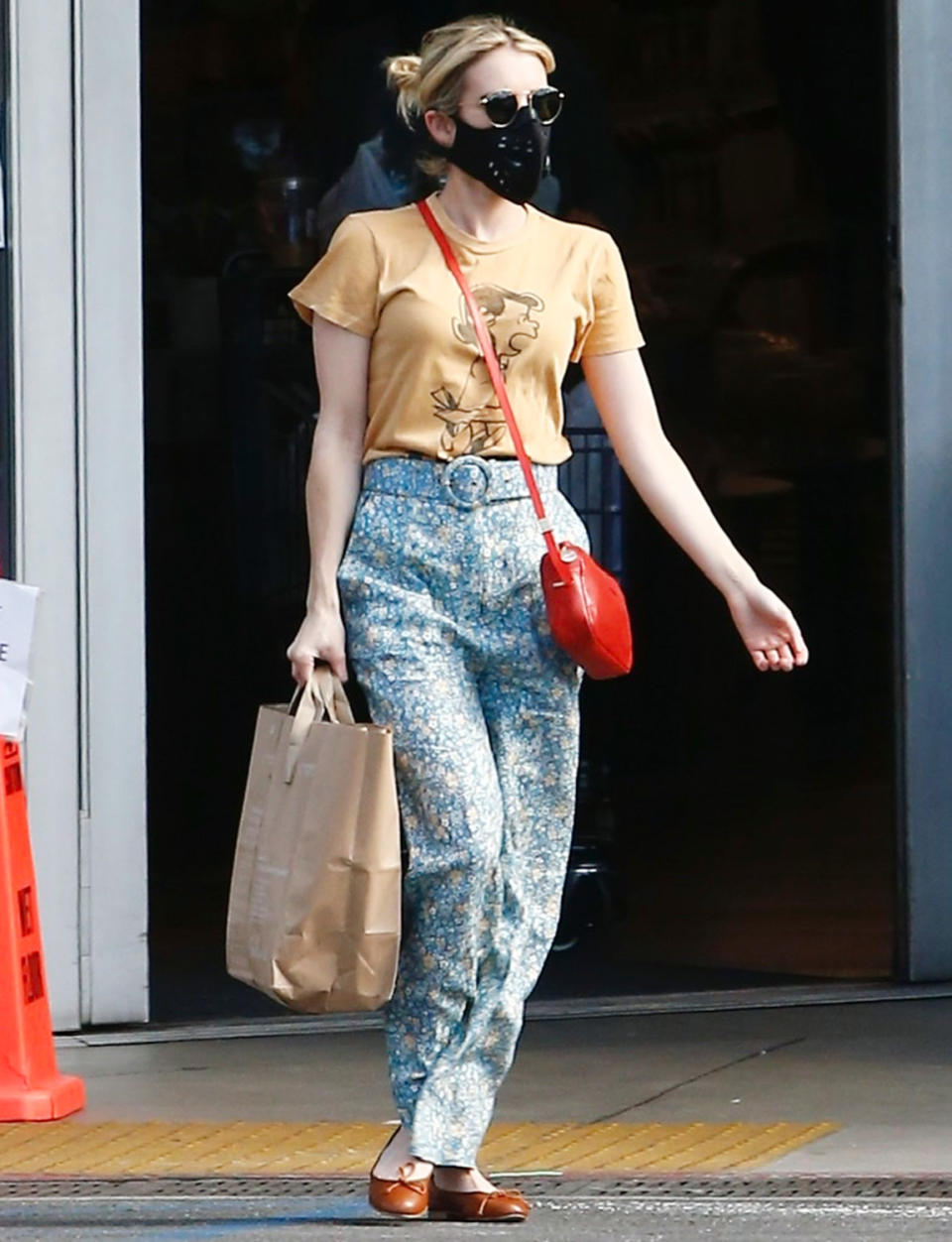 <p>Emma Roberts sports a Peanuts gang T-shirt and blue bell bottoms as she shops for groceries in Los Feliz, California, on Tuesday.</p>