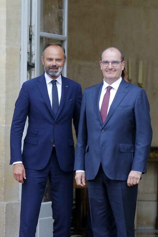 Outgoing French prime minister Edouard Philippe, left, and newly appointed premier Jean Castex pose before the handover ceremony (Michel Euler/AP)