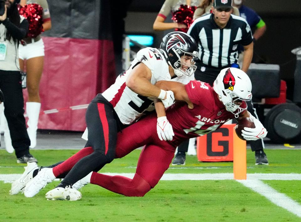 Nov 12, 2023; Glendale, AZ, USA; Arizona Cardinals wide receiver Michael Wilson (14) is down short of the goal line against Atlanta Falcons linebacker Kaden Elliss (55) in the second half at State Farm Stadium. Mandatory Credit: Rob Schumacher-Arizona Republic