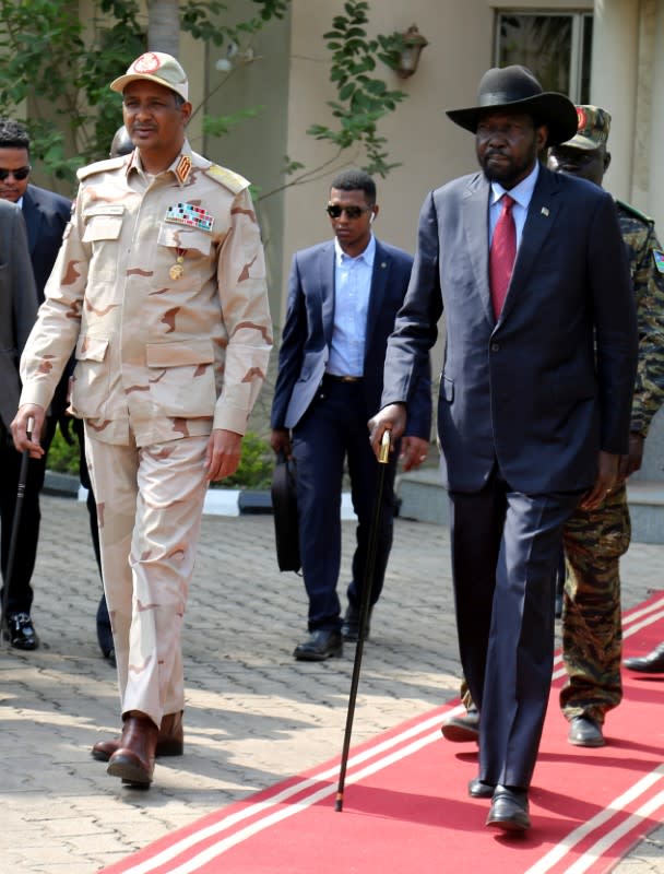 South Sudan's President Salva Kiir Mayardit and deputy head of the military council and head of the RSF Lieutenant General Mohamed Hamdan Dagalo arrive for the signing ceremony of the Sudan's initial political and security deal with rebel group, in Juba