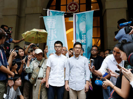 Pro-democracy activists Joshua Wong (L) and Nathan Law walk out of the Court of Final Appeal after being granted bail in Hong Kong, China, October 24, 2017. REUTERS/Bobby Yip