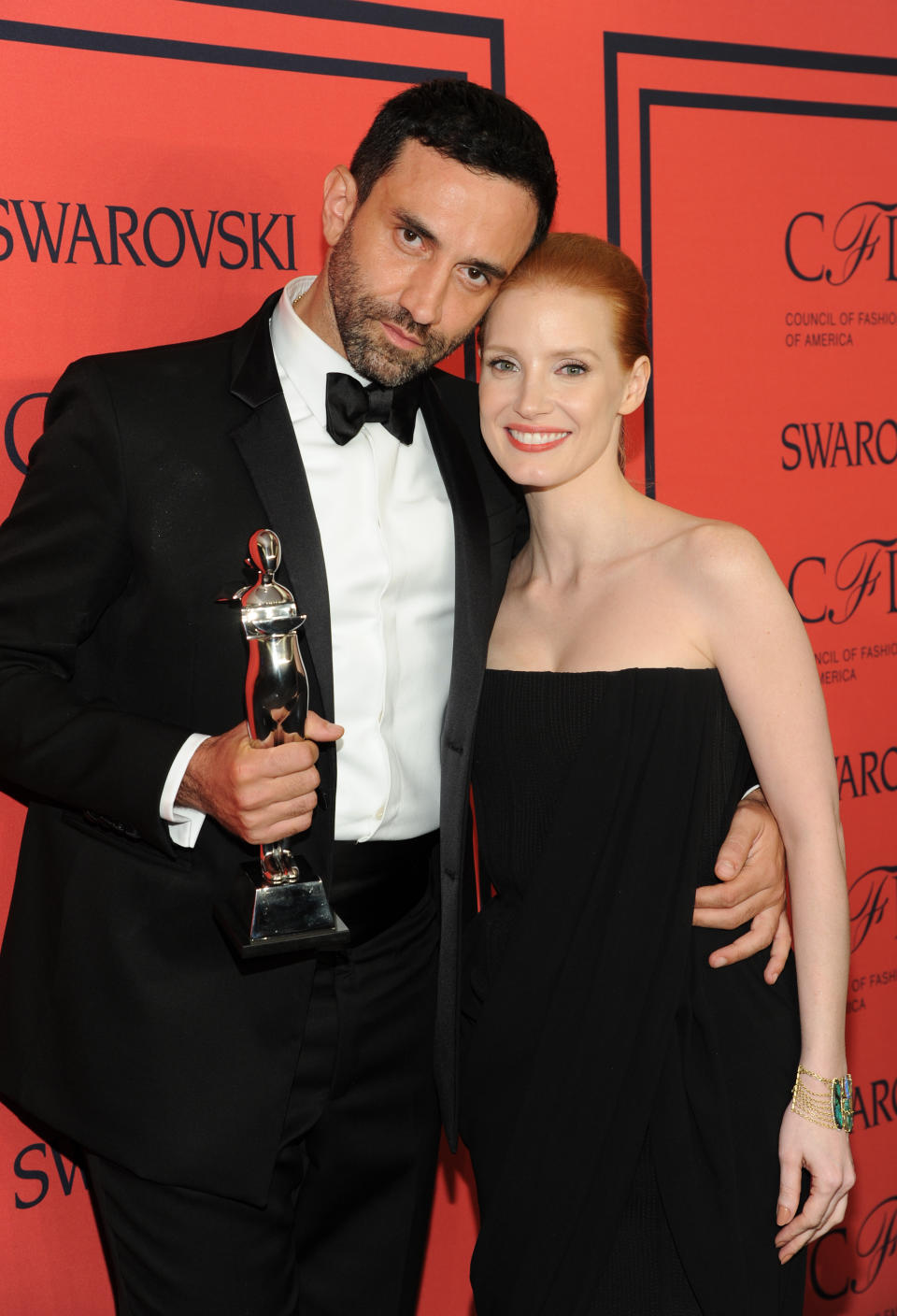 International Award honoree Riccardo Tisci, left, and actress Jessica Chastain pose in the press room at the 2013 CFDA Fashion Awards at Alice Tully Hall on Monday, June 3, 2013 in New York. (Photo by Evan Agostini/Invision/AP)