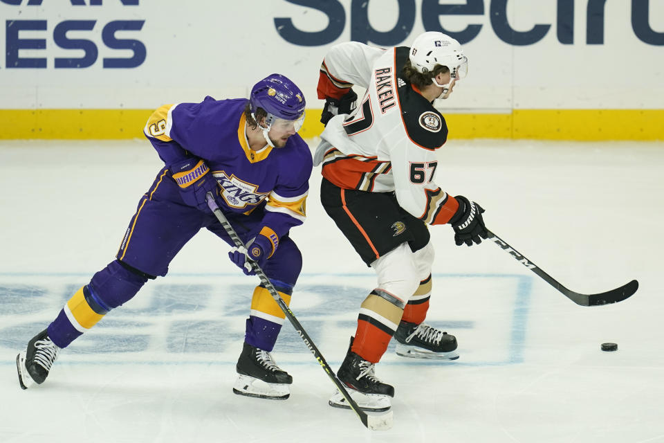 Los Angeles Kings right wing Adrian Kempe (9) defends against Anaheim Ducks center Rickard Rakell (67) during the third period of an NHL hockey game Monday, April 26, 2021, in Los Angeles. (AP Photo/Ashley Landis)