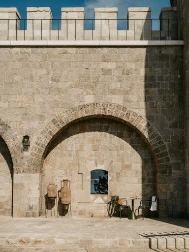 An archway and window can be seen inside the Maluma Island Hotel.