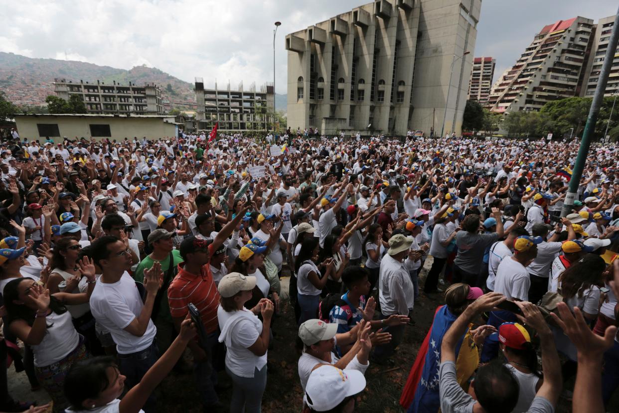 People gather for a silent protest outside the Venezuelan Episcopal Conference in homage to the at least 20 people killed in unrest. - Copyright 2017 The Associated Press. All rights reserved.