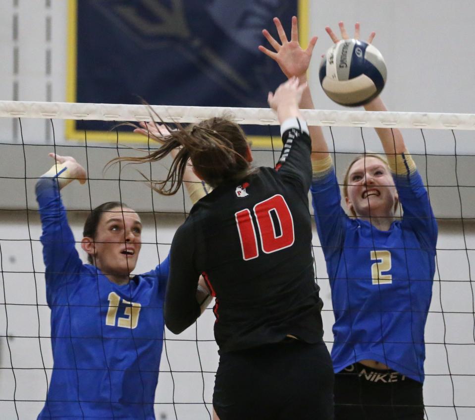 Schroeder's Angelina Fitzharris (2) gets the block at the net on a spike from Penfield's Cassidy Cone.