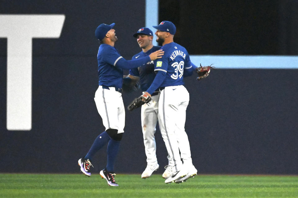 Toronto Blue Jays' George Springer, left to right, Daulton Varsho and Kevin Kiermaier celebrate their victory over the Houston Astros in a baseball game, Tuesday, July 2, 2024, in Toronto. (Jon Blacker/The Canadian Press via AP)