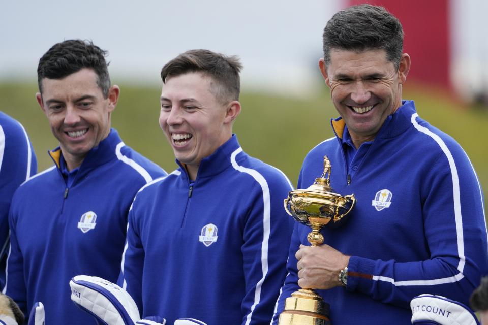 Team Europe captain Padraig Harrington, Team Europe's Matt Fitzpatrick and Team Europe's Rory McIlroy pose for a team photo during a practice day at the Ryder Cup at the Whistling Straits Golf Course Tuesday, Sept. 21, 2021, in Sheboygan, Wis. (AP Photo/Jeff Roberson)