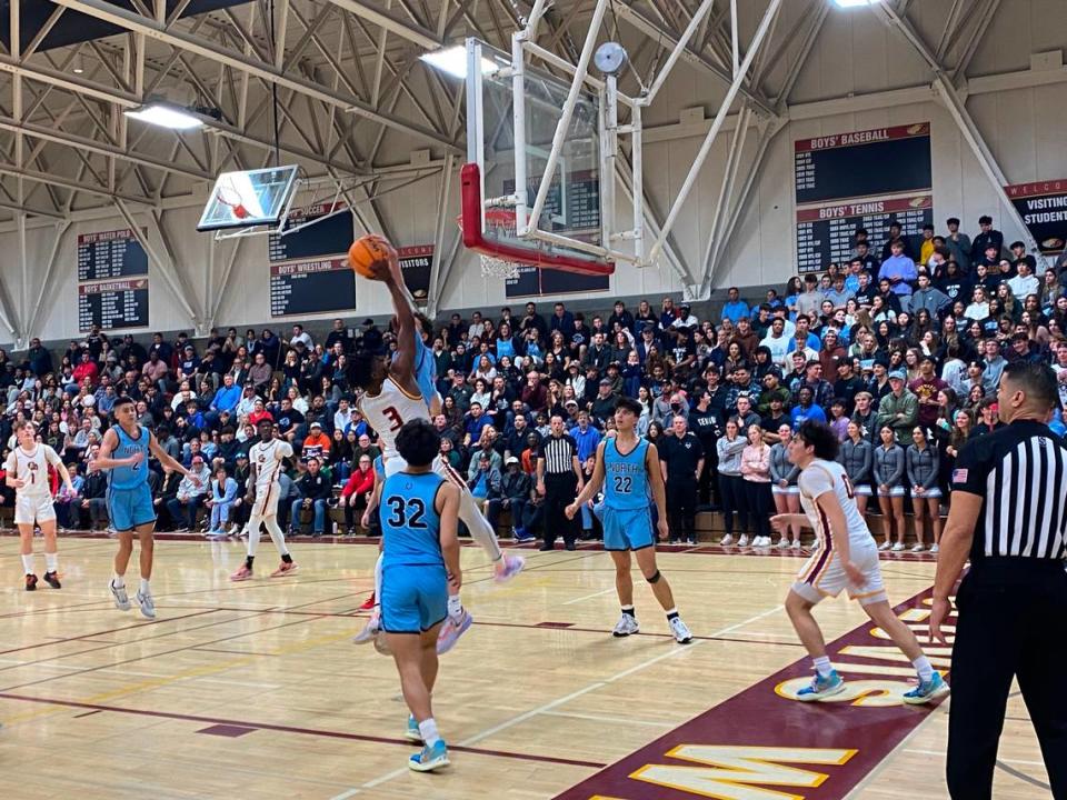 Clovis West guard Marshel Sanders is defended by Clovis North forward Malik Musleh in a high school boys basketball game on Friday, Jan. 27, 2023.