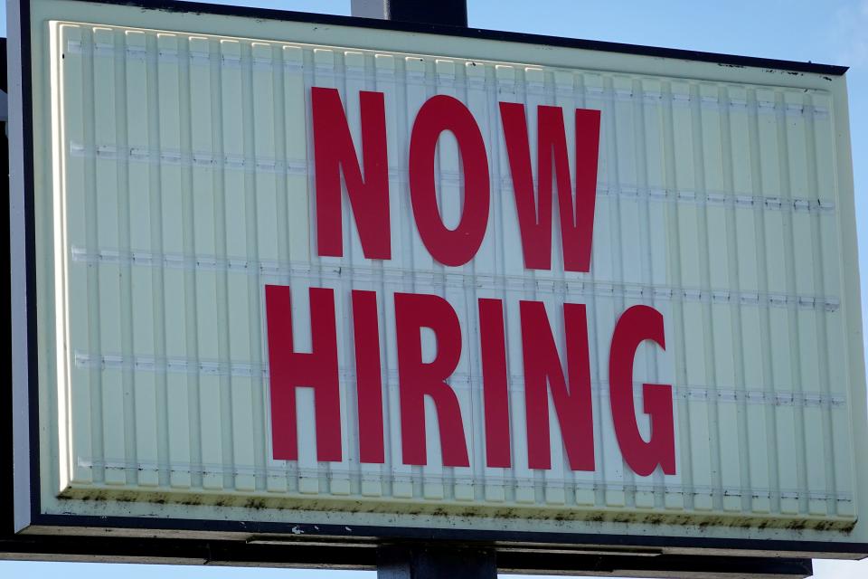 A Now Hiring sign at a grocery store in Florida