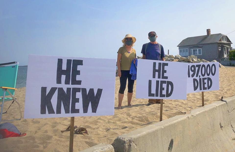 Democrats Tina Tarr and George Hughes protested the president's handling of the pandemic in Saco, Maine.