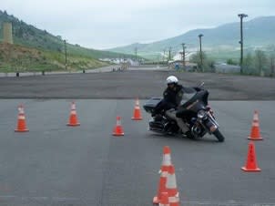 Police on a motorcycle running a course.