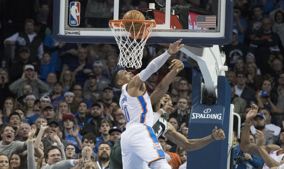 Giannis Antetokounmpo dunks the winning field goal over Russell Westbrook. (AP Photo/J Pat Carter)