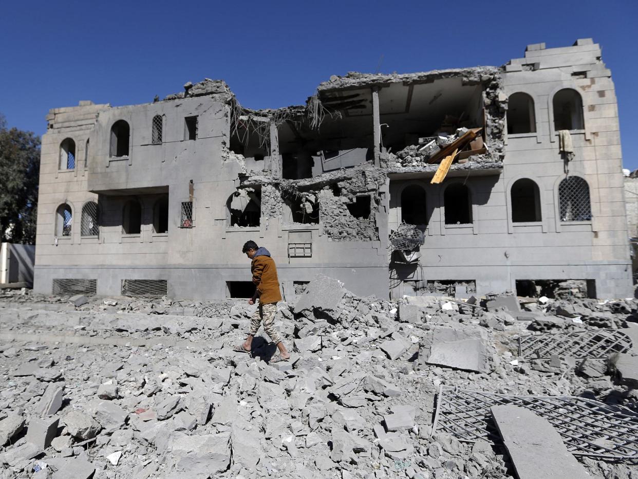 Residents picking over the wreckage of a bombed home in Sanaa: Getty Images/AFP