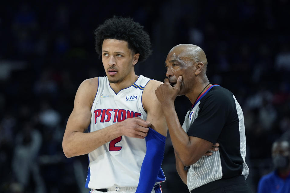 Detroit Pistons guard Cade Cunningham (2) talks with referee Leon Wood during the first half of an NBA basketball game against the Denver Nuggets, Tuesday, Jan. 25, 2022, in Detroit. (AP Photo/Carlos Osorio)