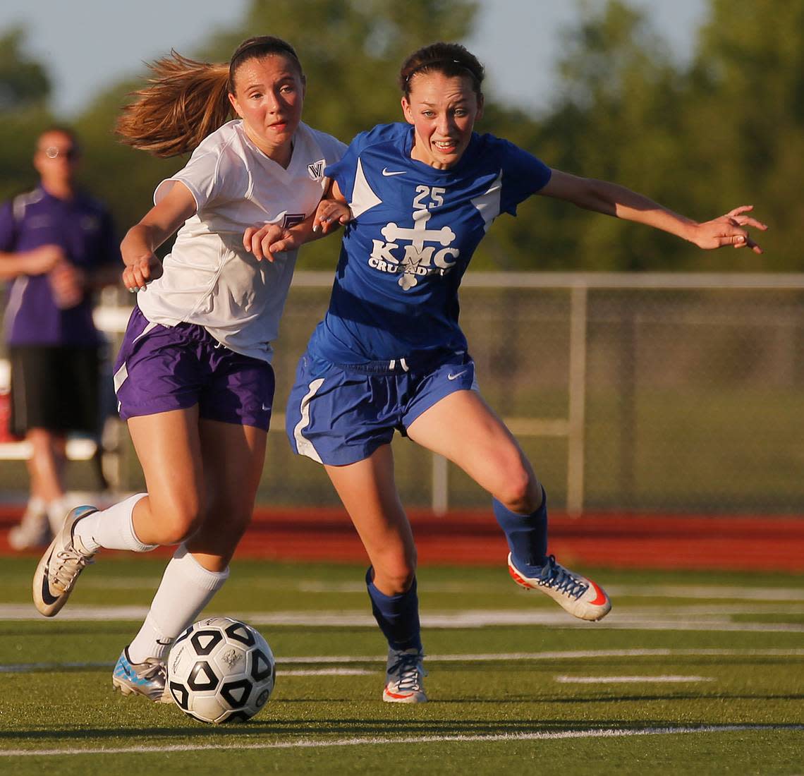 Kapaun’s Grace Hagan, right, fights for the ball with Valley Center’s Kennedy Weaver, left, in the 5A quarterfinal at Valley Center Tuesday. (May 21, 2013)