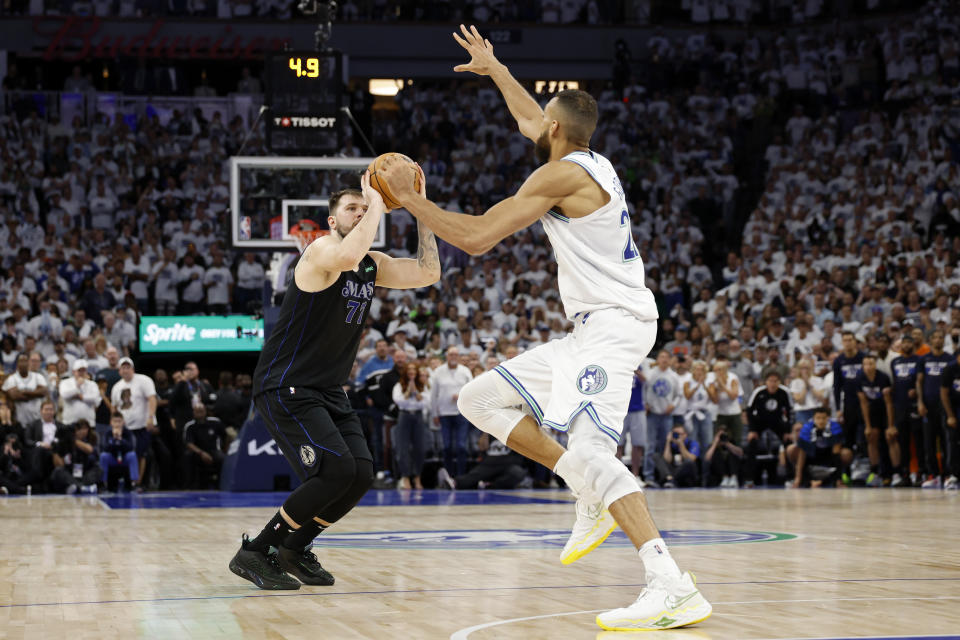 MINNEAPOLIS, MINNESOTA - MAY 24: Luka Doncic #77 of the Dallas Mavericks shoots a three point basket against Rudy Gobert #27 of the Minnesota Timberwolves during the fourth quarter in Game Two of the Western Conference Finals at Target Center on May 24, 2024 in Minneapolis, Minnesota. NOTE TO USER: User expressly acknowledges and agrees that, by downloading and or using this photograph, User is consenting to the terms and conditions of the Getty Images License Agreement. (Photo by David Berding/Getty Images)