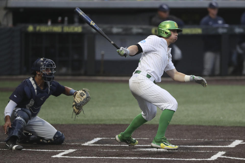 Oregon's Drew Cowley, right, hits a walkoff RBI-single during an NCAA college baseball tournament super regional game against Oral Roberts, Friday, June 9, 2023, in Eugene, Ore. (AP Photo/Amanda Loman)