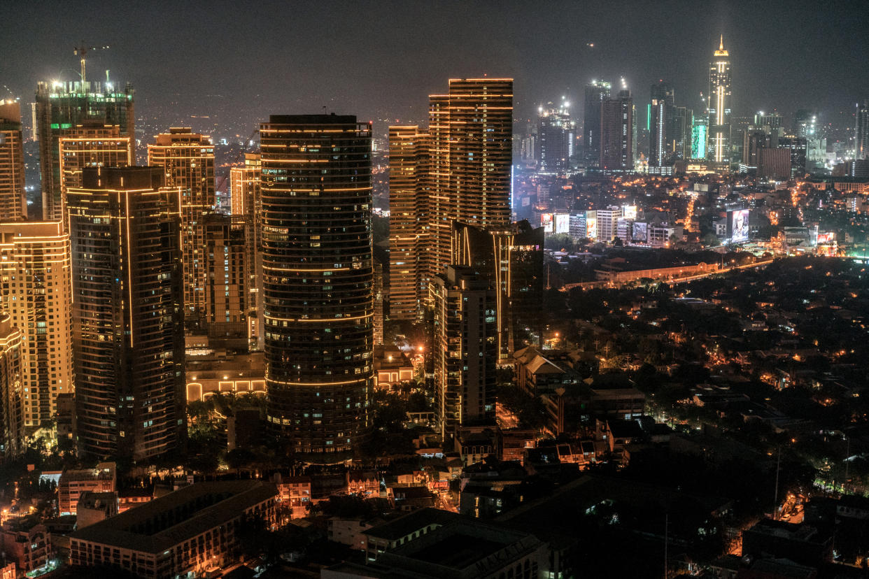 Buildings stand illuminated at night in Makati City, the Philippines. (Photo: Getty Images)