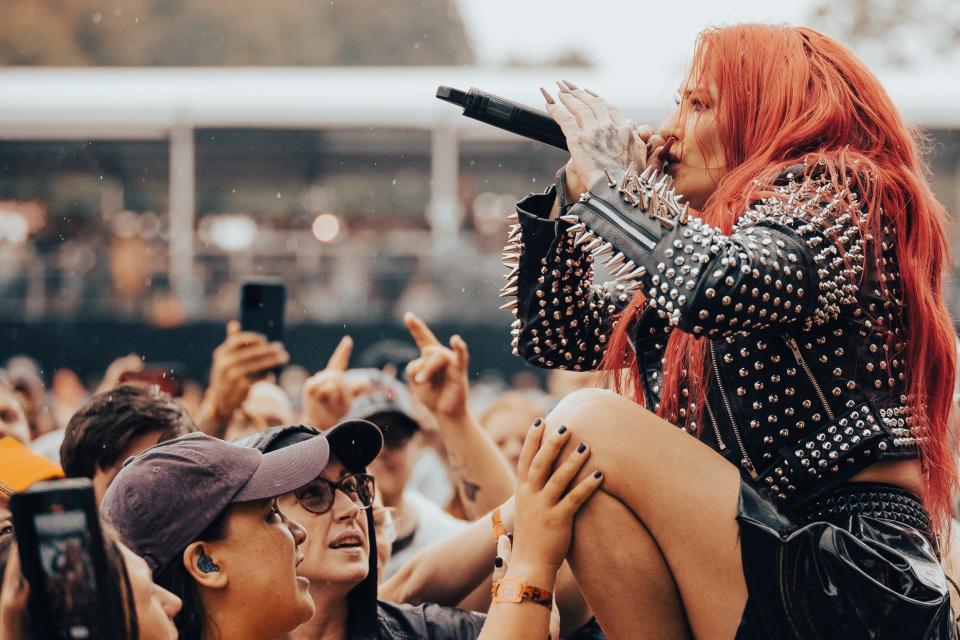 Heidi Shepherd of the Los Angeles band Butcher Babies gets close to the crowd at INKcarceration Music and Tattoo Festival in Mansfield on Sunday.