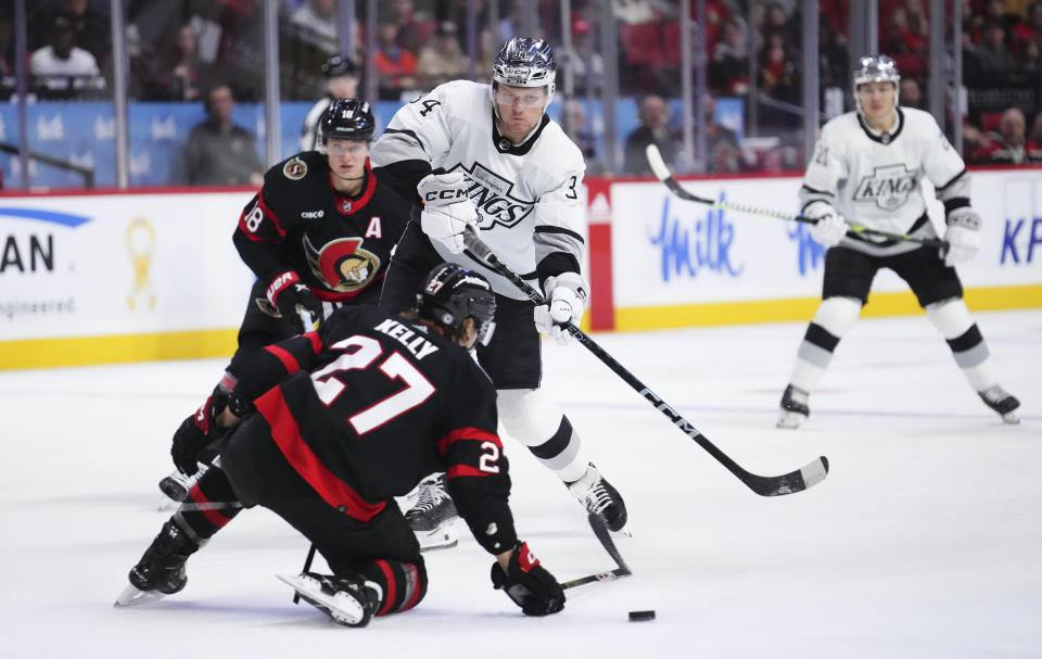 Los Angeles Kings right wing Arthur Kaliyev (34) puts the puck around Ottawa Senators left wing Parker Kelly (27) during the second period of an NHL hockey game Thursday, Nov. 2, 2023, in Ottawa, Ontario. (Sean Kilpatrick/The Canadian Press via AP)