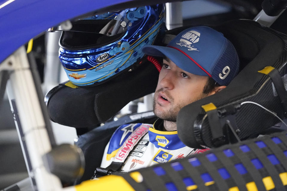 Chase Elliott gets ready to exit his car in his garage during practice for the Daytona 500 auto race at Daytona International Speedway, Saturday, Feb. 19, 2022, in Daytona Beach, Fla.. (AP Photo/John Raoux)