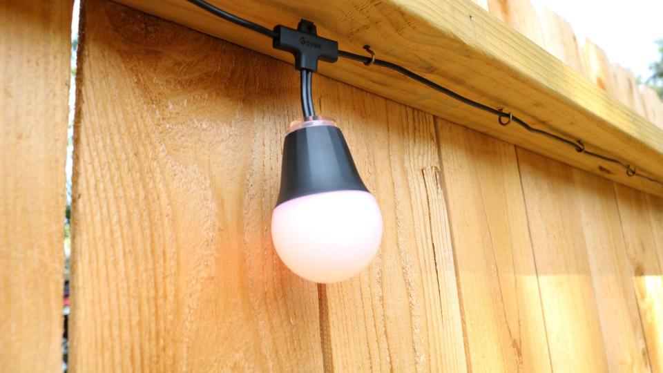 Govee's H1 string lights hanging from hooks on a fence