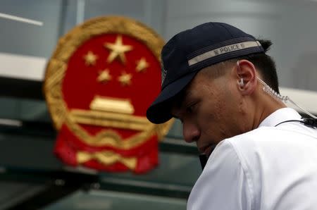 A policeman is seen on duty outside China's Liaison Office during a protest on the disappearance of five booksellers in Hong Kong, China January 4, 2016. REUTERS/Bobby Yip/File Photo