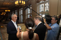 Major League Baseball Commissioner Rob Manfred, left, speaks with the news media after a meeting of MLB owners, Thursday, Feb. 9, 2023, in Palm Beach, Fla. (AP Photo/Lynne Sladky)